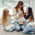 Family playing with cat at home in winter - Product Spotlight: Amana Furnaces