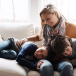 Mom and two boys at home on couch - 3 Eco-Friendly Features of Amana Furnaces: Heat Your Home Sustainably