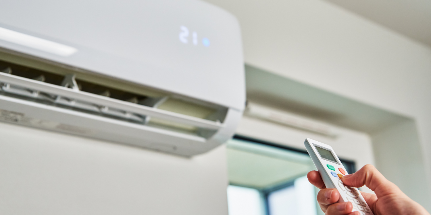 Ductless AC Unit being turned on by a remote - Your Complete Guide to Air Conditioner Care and Efficiency