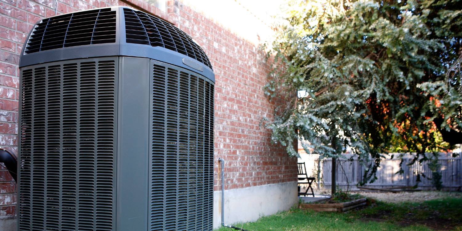 Outdoor AC unit against red brick home - Your Complete Guide to Air Conditioner Care and Efficiency