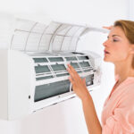 women checks air conditioner