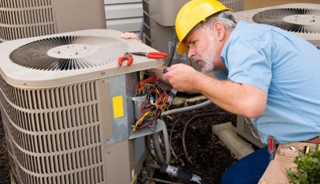 Technician reapairing air conditioner in Caledon