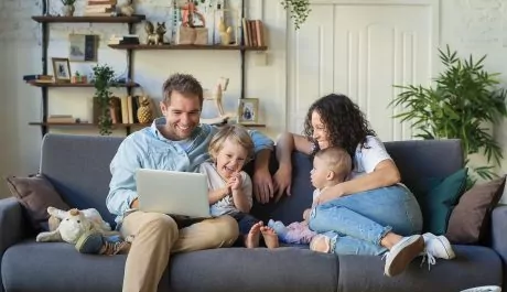 Young beautiful happy family relaxing at home