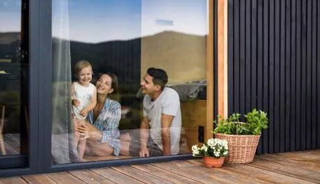 Young family with small daughter indoors, weekend away in container house in countryside.