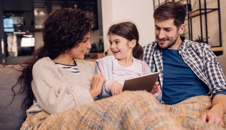 family sitting on couch furnace installation repair and maintenance in Caledon